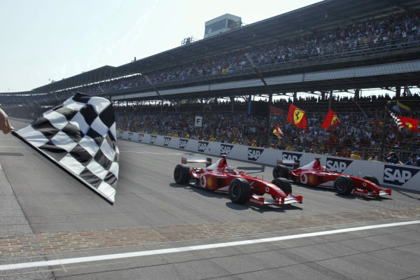 Rubens Barrichello, Ferrari F2002, (nearest camera), wins from Michael Schumacher, Ferrari F2002, who had slowed as he approached the finish line to allow his teammate alongside. Rubens Barrichello, Ferrari F2002, (nearest camera), wins from Michael Schumacher, Ferrari F2002, who had slowed as he approached the finish line to allow his teammate alongside.