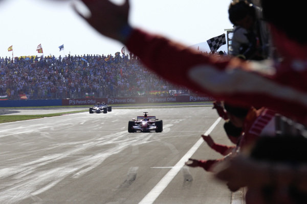 Race winner Felipe Massa, Ferrari 248 F1 being welcomed by his cheering team after claiming his first F1 victory.