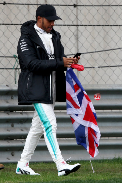 Shanghai International Circuit, Shanghai, China.  Friday 07 April 2017. 
Lewis Hamilton, Mercedes AMG, takes to the track to entertain the fans and picks up a Union Flag.
World Copyright: Charles Coates/LAT Images 
ref: Digital Image AN7T4839