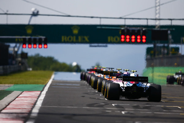 Stoffel Vandoorne, McLaren MCL33 Renault, Esteban Ocon, Force India VJM11 Mercedes, and Sergey Sirotkin, Williams FW41 Mercedes, at the back of the grid as the drivers wait for the start lights to go out.