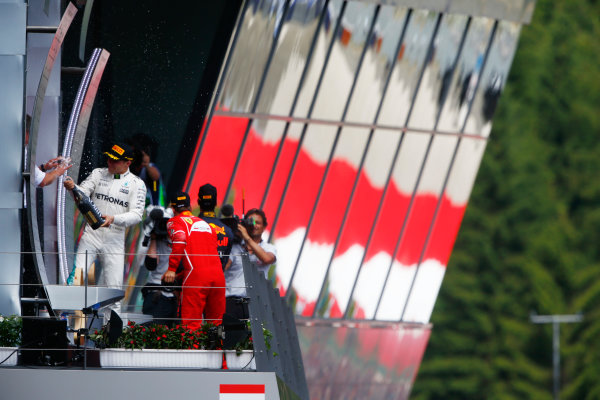 Red Bull Ring, Spielberg, Austria.
Sunday 09 July 2017.
Winner Valtteri Bottas, Mercedes AMG, sprays champagne on the podium with Sebastian Vettel, Ferrari, and Daniel Ricciardo, Red Bull Racing. 
World Copyright: Andy Hone/LAT Images
ref: Digital Image _ONY3609